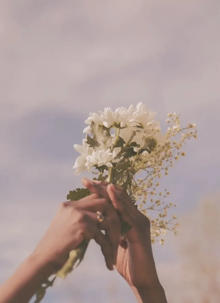 Hands holding flowers to welcome spring