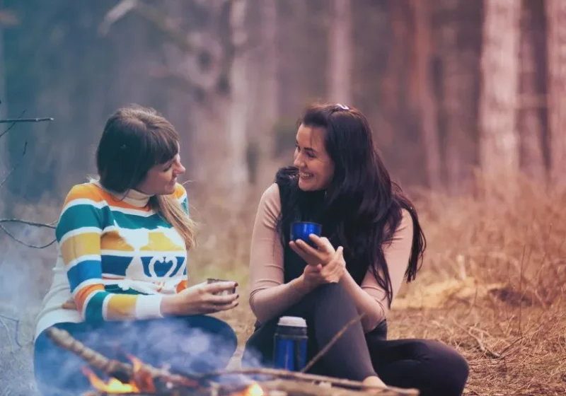 two women having a conversation in the woods