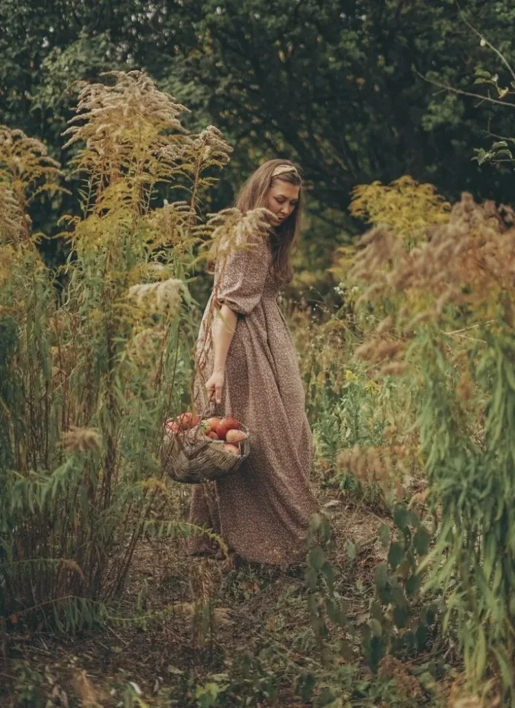 woman with a basket of harvested apples