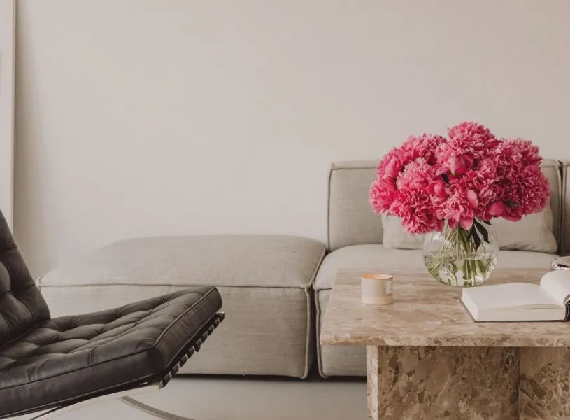 home decor with a black seat, neutral color sofa and fresh pink peonies