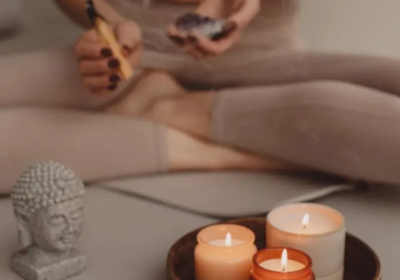 woman lighting candles to prepare for mindfulness/meditation
