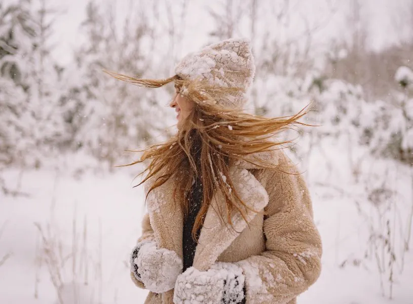 woman enjoying her own company playing in the snow