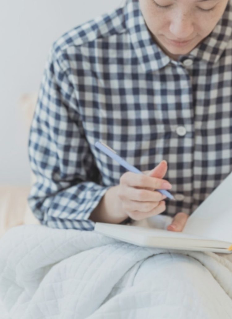 woman doing her year-end journal reflection writing