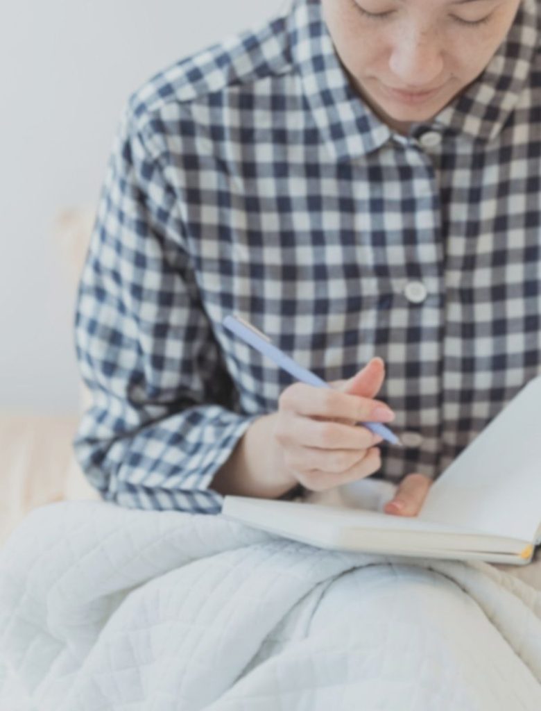 woman doing her year-end journal reflection writing