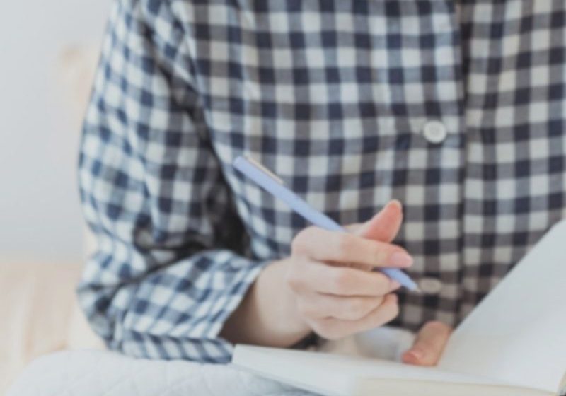 woman doing her year-end journal reflection writing