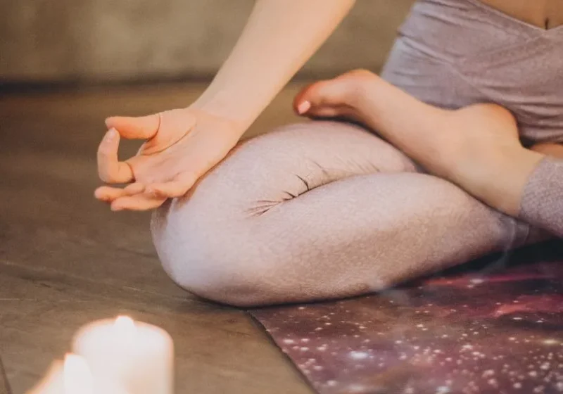 woman meditating as part of her evening routine to stop overthinking and for better sleep
