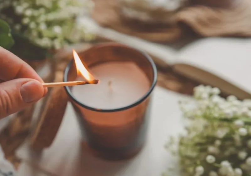 lighting an aromatic candle for better sleep at night