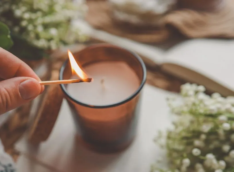 lighting an aromatic candle for better sleep at night
