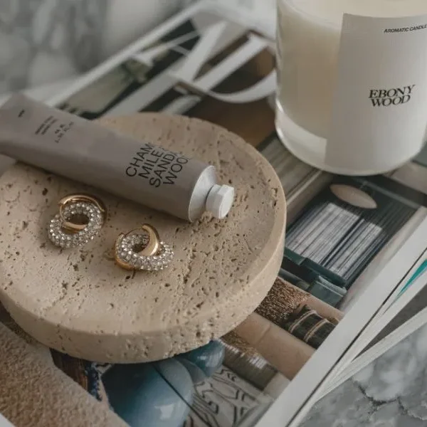 hand cream, earring and candle