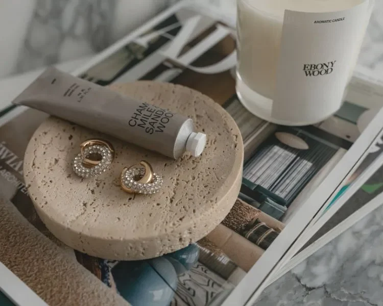 hand cream, earring and candle