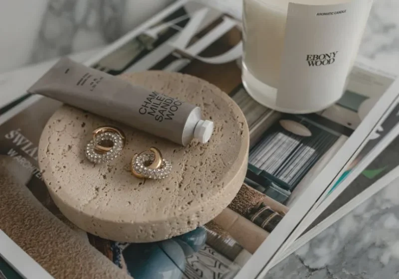 hand cream, earring and candle