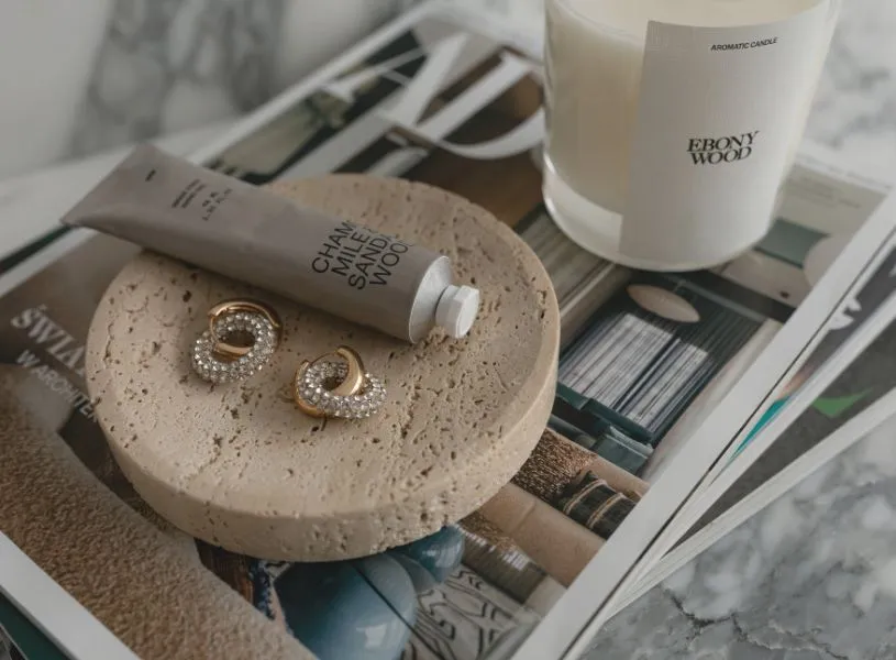 hand cream, earring and candle