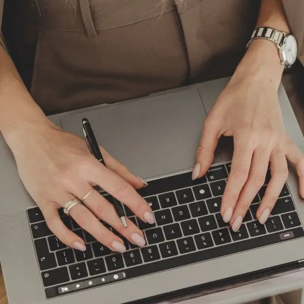 woman typing on her laptop