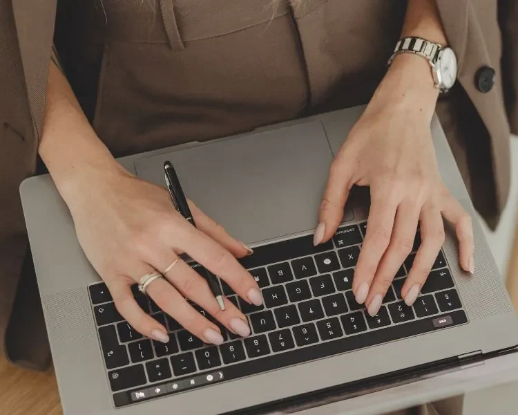 woman typing on her laptop