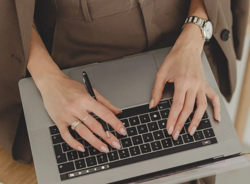 woman typing on her laptop