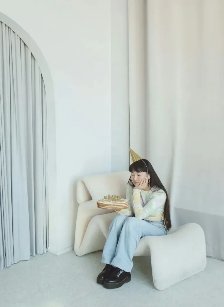 girl sitting on a chair celebrating her birthday by herself