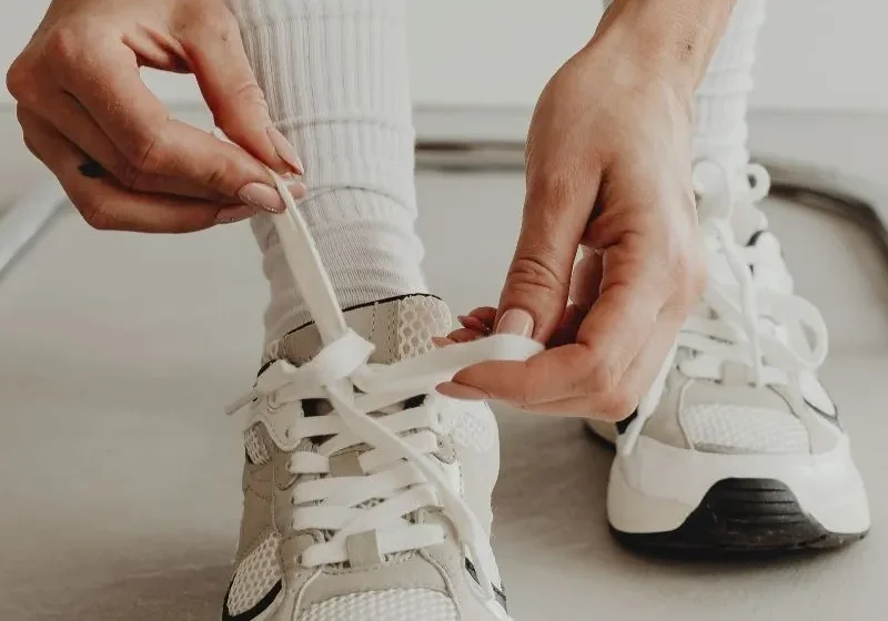 woman tying her shoe laces ready to work hard and hustle