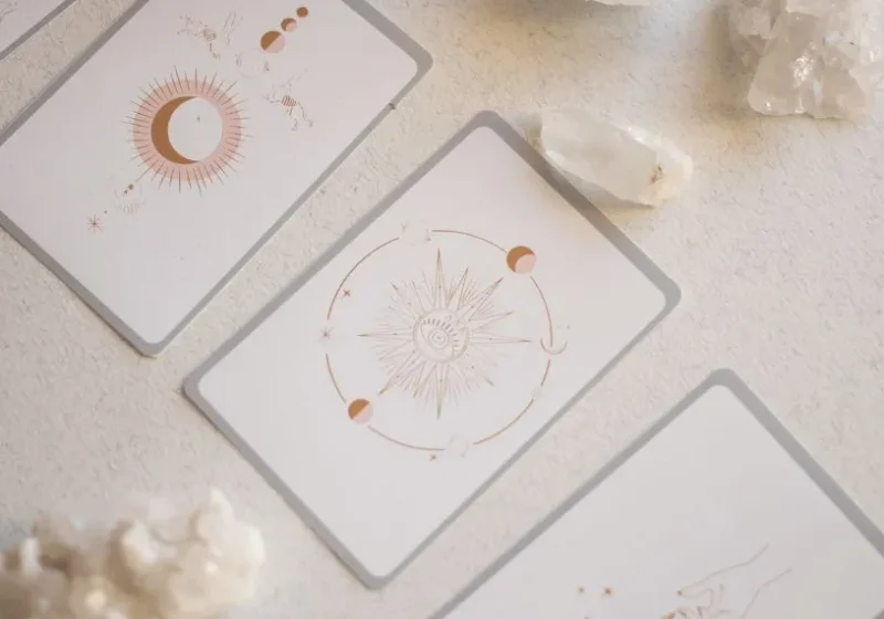 three tarot cards and some crystals