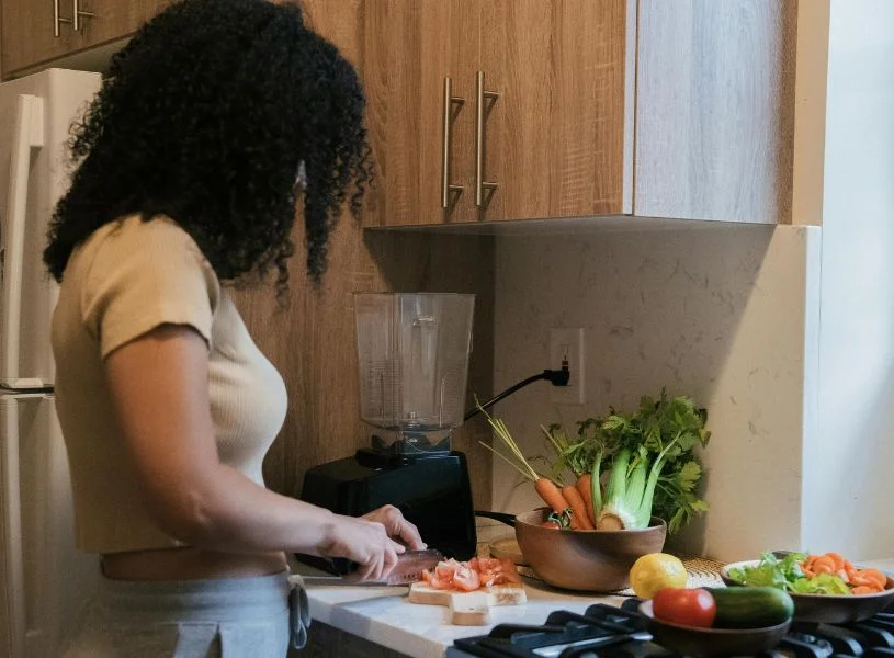 woman cooking for herself on valentine's day - spending time alone on valentine's day