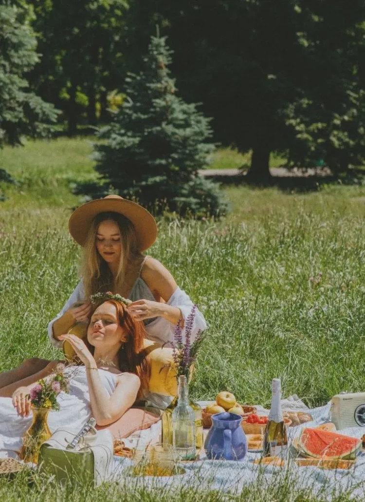 two girlfriends having picnic in the park