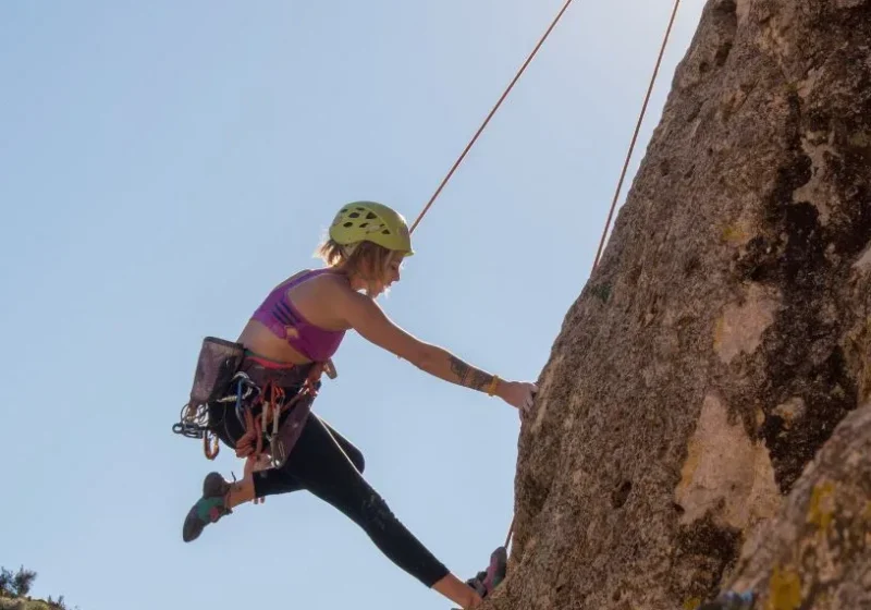 woman challenging herself to rock climb