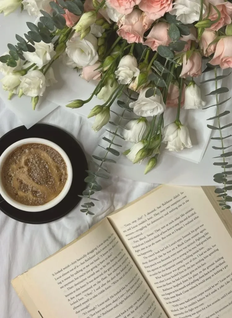 flowers, coffee and book on table