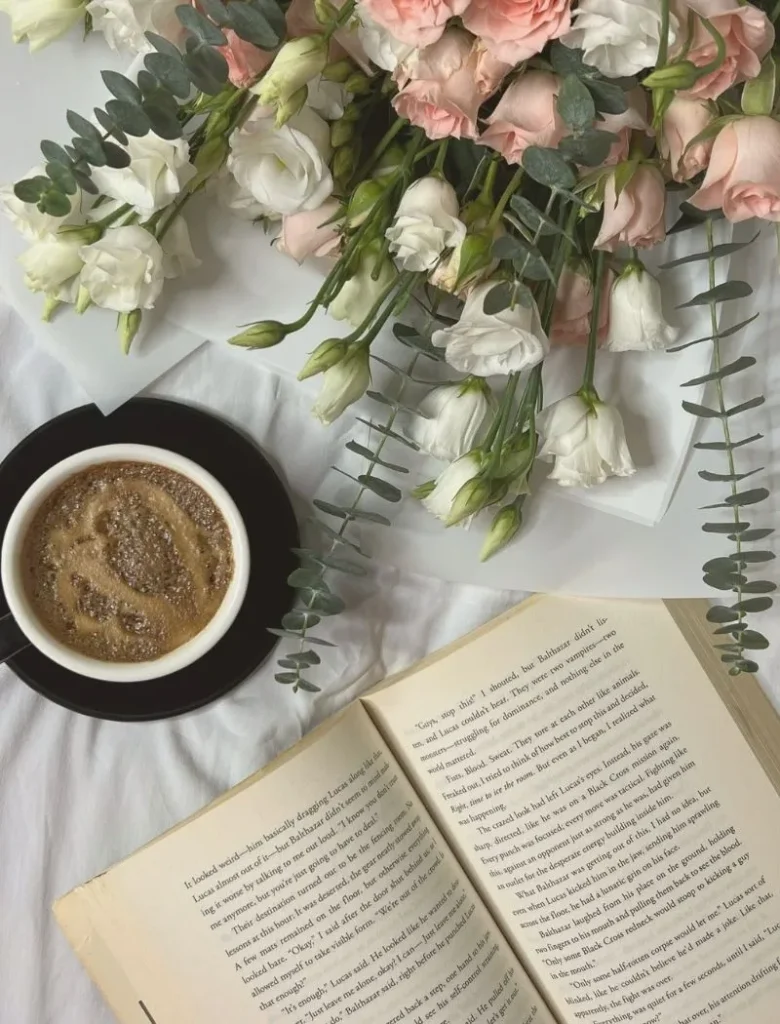 flowers, coffee and book on table