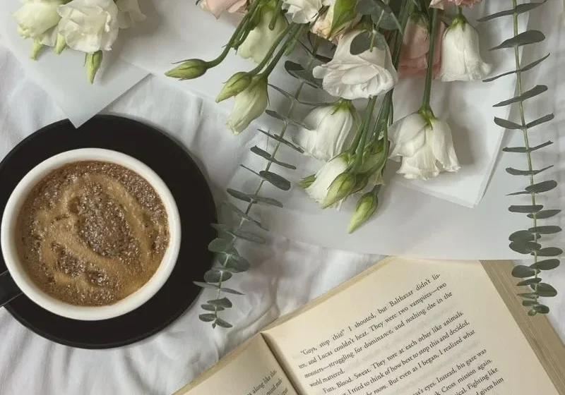 flowers, coffee and book on table