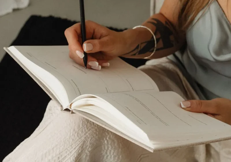 woman writing in their journal