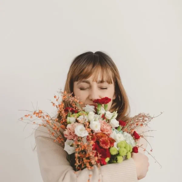 woman hugging herself and flowers