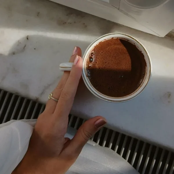 a hand holding coffee