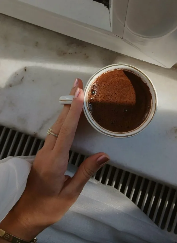 a hand holding coffee