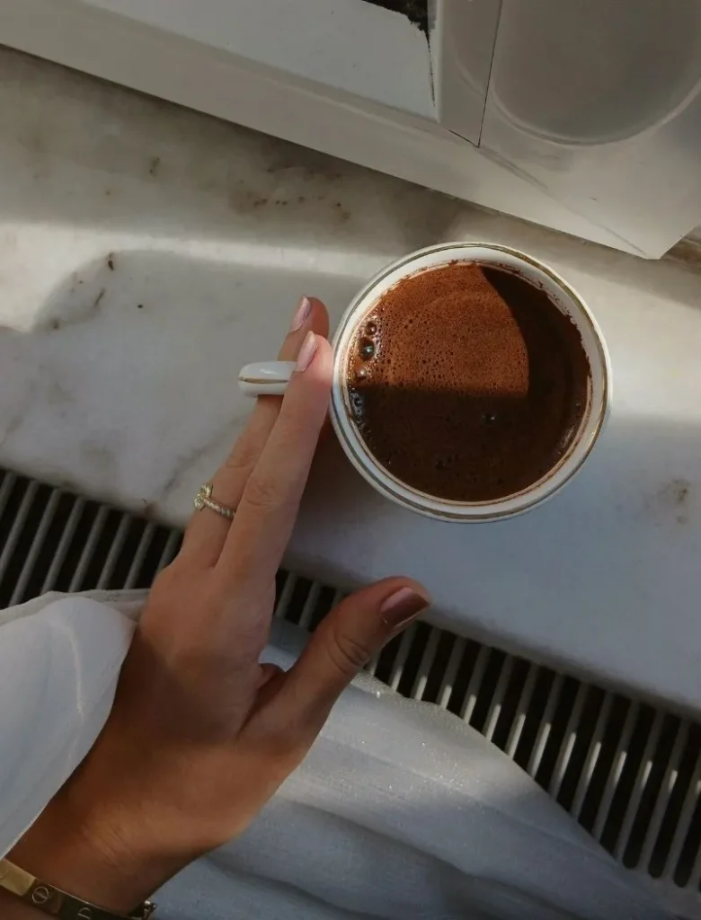 a hand holding coffee