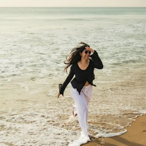 a happy woman by the beach water enjoy what she has in life