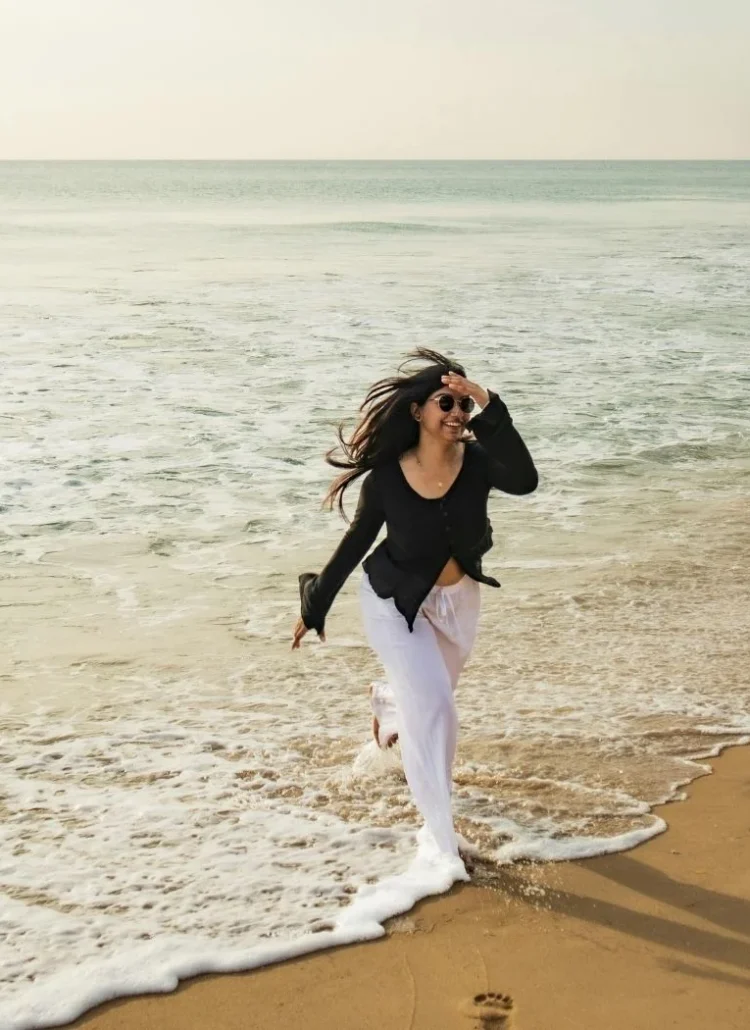 a happy woman by the beach water enjoy what she has in life