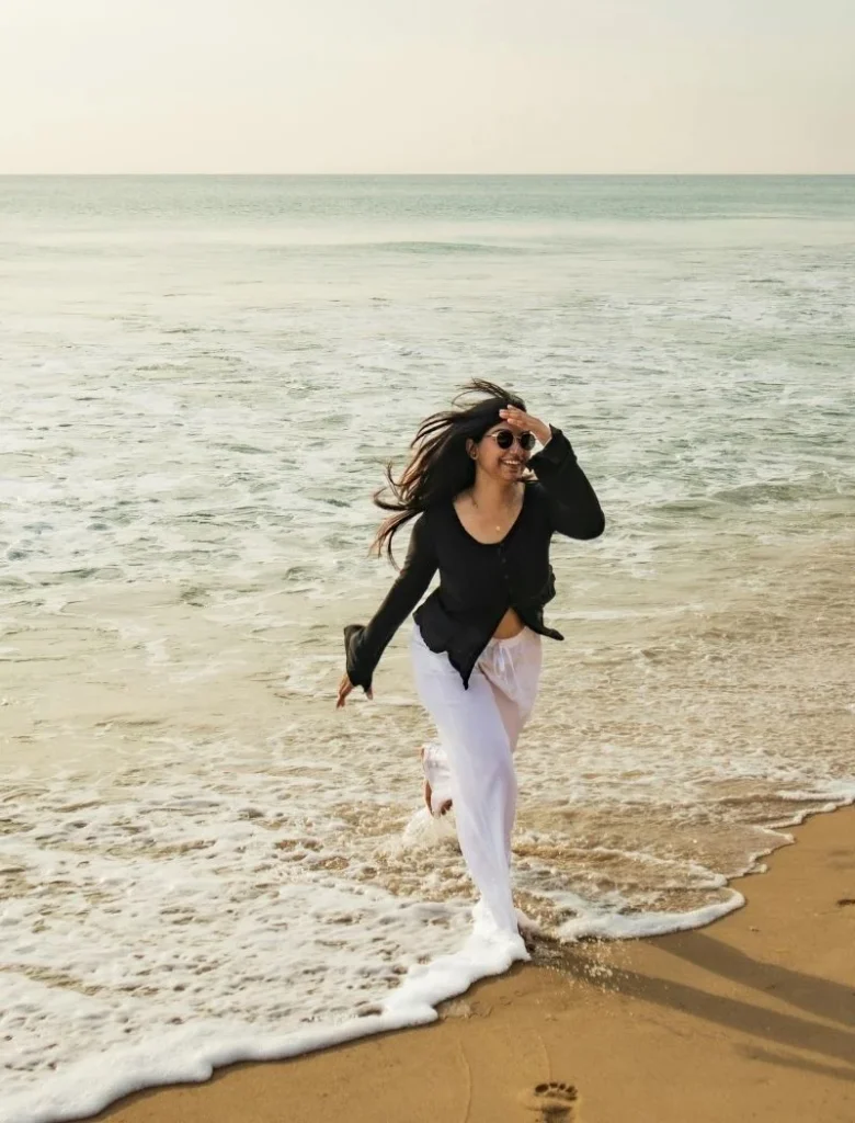 a happy woman by the beach water enjoy what she has in life