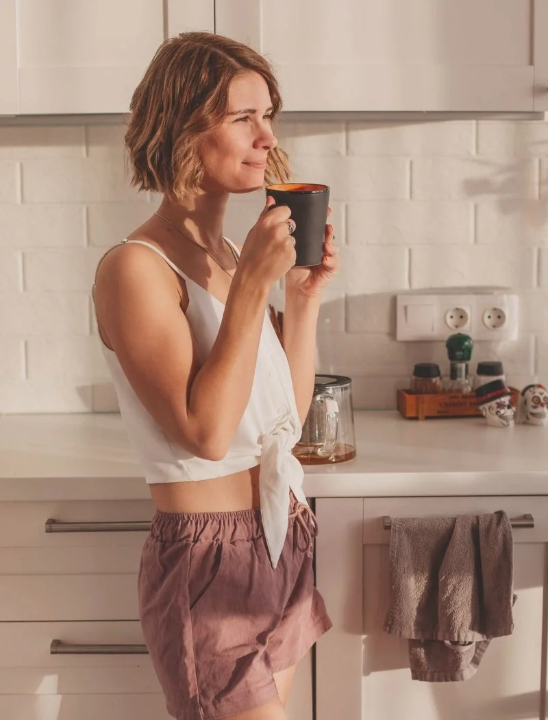 Weekend reset routine - woman journaling and drinking coffee on Saturday morning